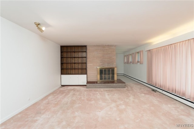 unfurnished living room with baseboards, a baseboard radiator, carpet floors, and a large fireplace