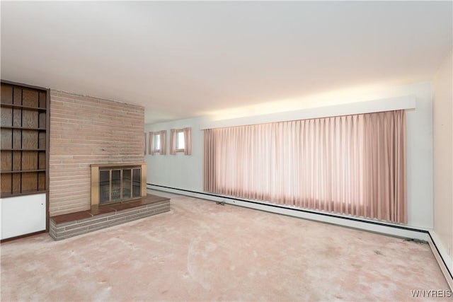 unfurnished living room with built in features, baseboard heating, carpet flooring, and a brick fireplace