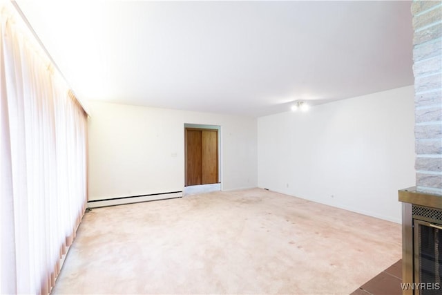 unfurnished living room with light colored carpet and baseboard heating