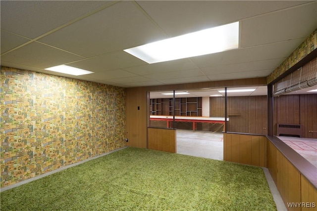 spare room featuring carpet floors, a paneled ceiling, and radiator