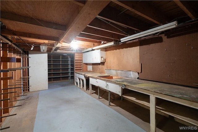 unfinished below grade area featuring a workshop area
