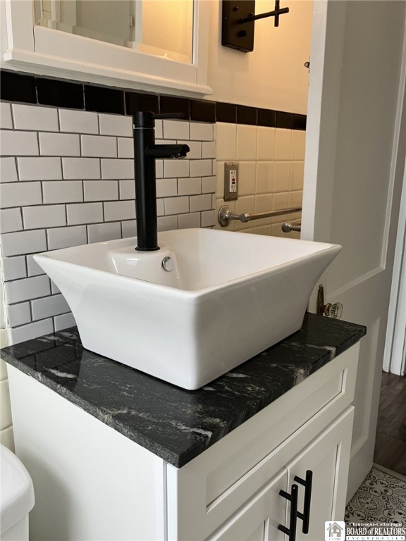 bathroom featuring tile walls and vanity