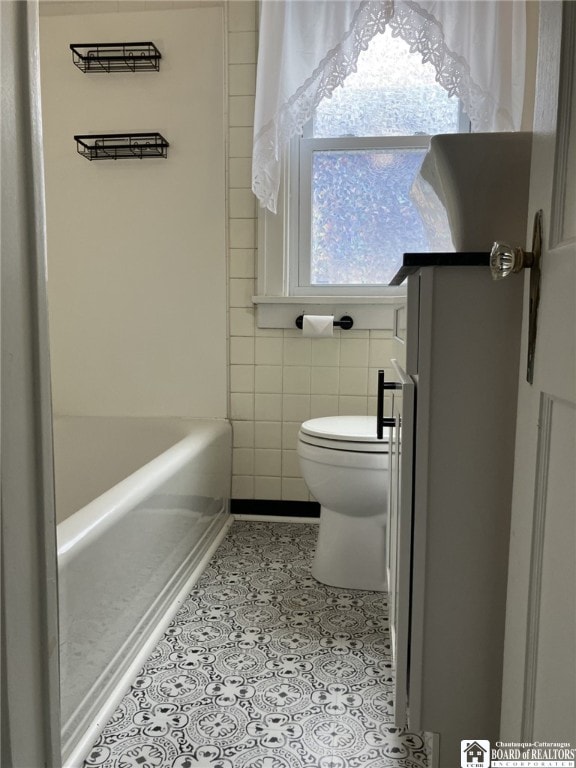 full bath with toilet and tile patterned floors