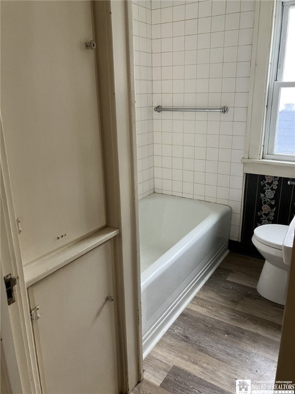 full bathroom featuring wood finished floors and toilet