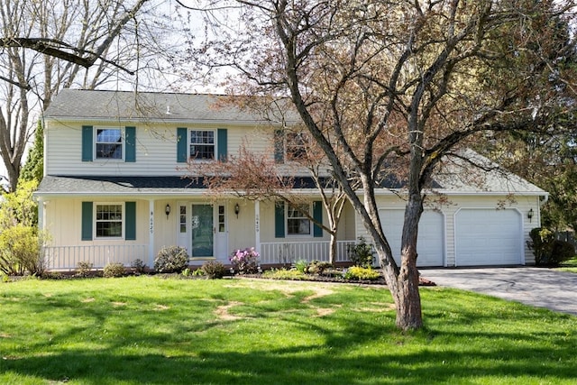 traditional home featuring a front lawn, a garage, board and batten siding, a porch, and driveway