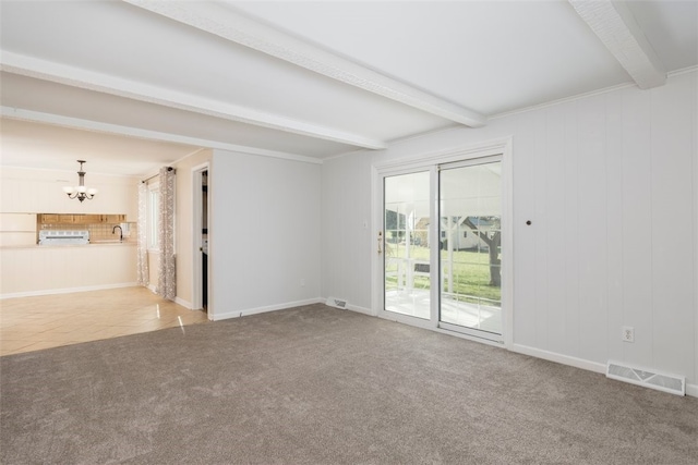 unfurnished living room featuring carpet flooring, a chandelier, baseboards, beamed ceiling, and visible vents