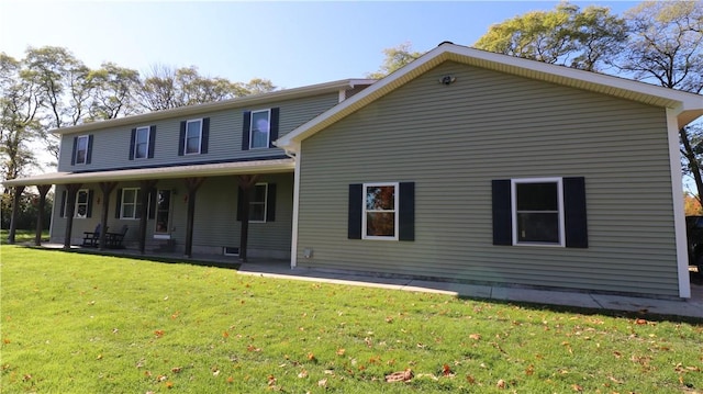 rear view of property featuring a yard