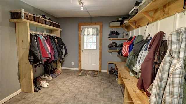 mudroom featuring baseboards and rail lighting