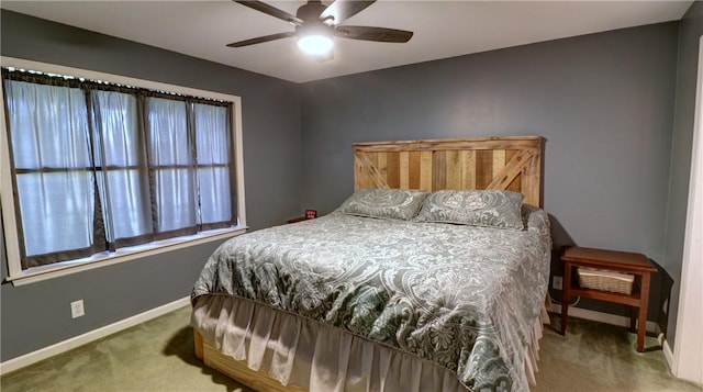 carpeted bedroom with baseboards and a ceiling fan
