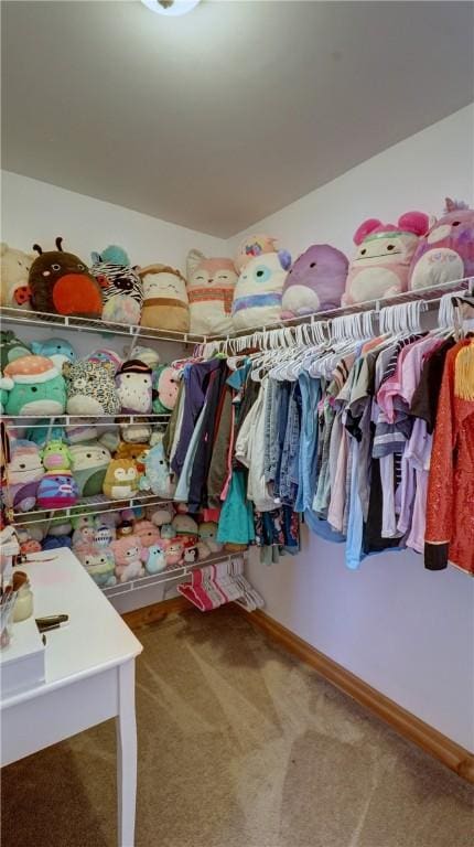 walk in closet with carpet floors