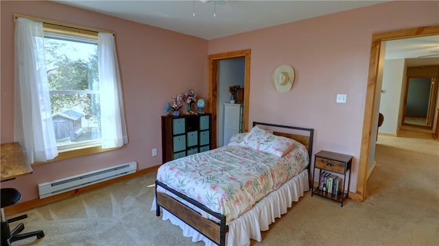 bedroom with carpet and baseboard heating