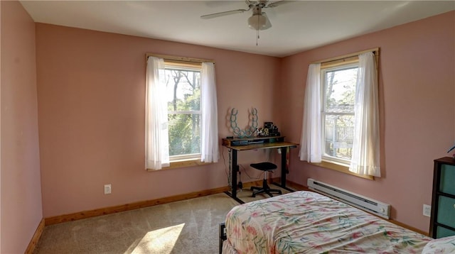 bedroom featuring multiple windows, baseboard heating, and light colored carpet