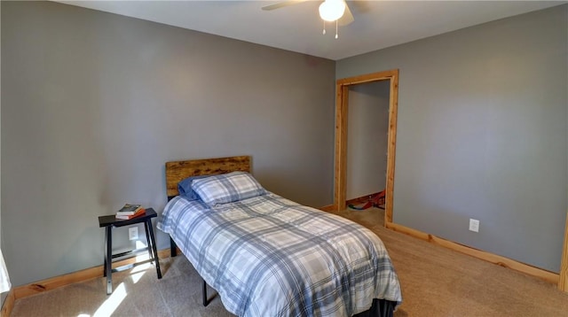 bedroom featuring baseboards, a ceiling fan, and carpet flooring
