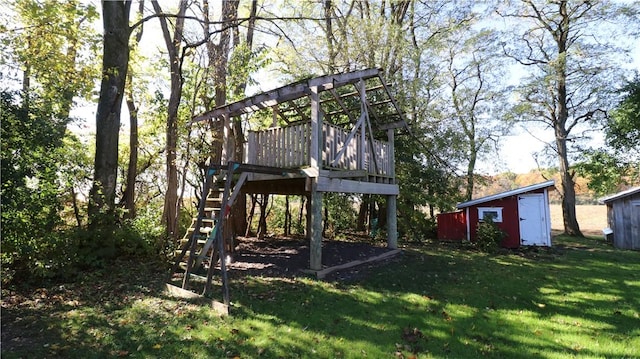 view of yard with a storage shed, stairs, an outdoor structure, and a wooden deck