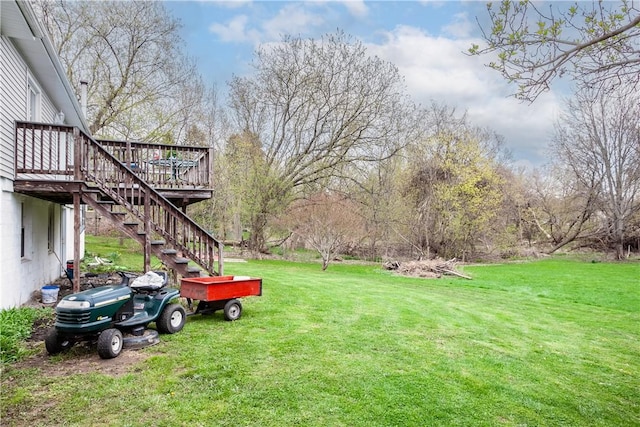 view of yard featuring a deck and stairway