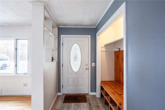 mudroom with crown molding, baseboards, and wood finished floors