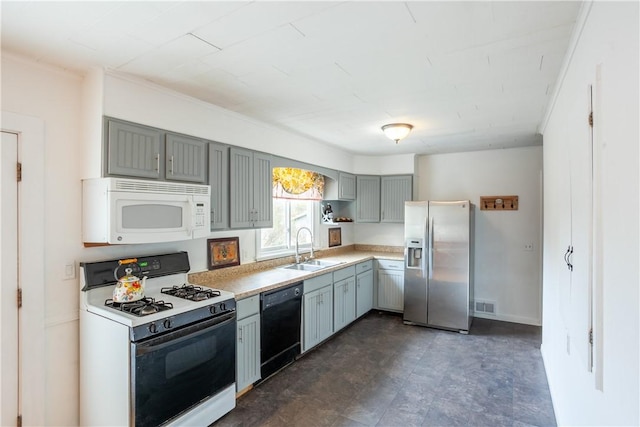 kitchen featuring a sink, visible vents, white appliances, light countertops, and gray cabinetry