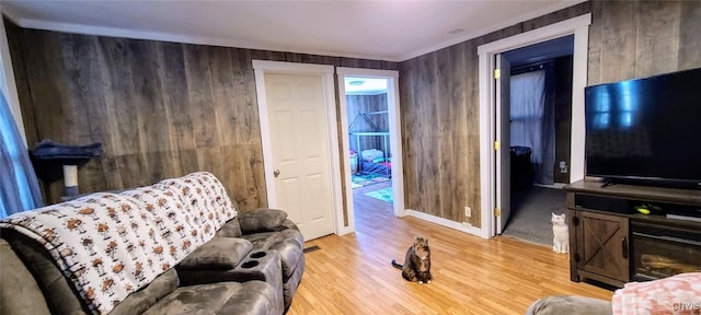 sitting room with wood walls and wood finished floors