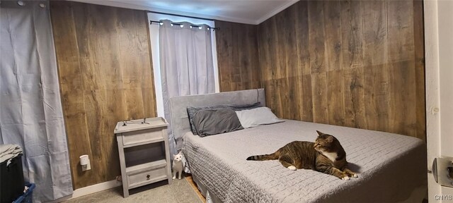 bedroom featuring carpet floors and wooden walls