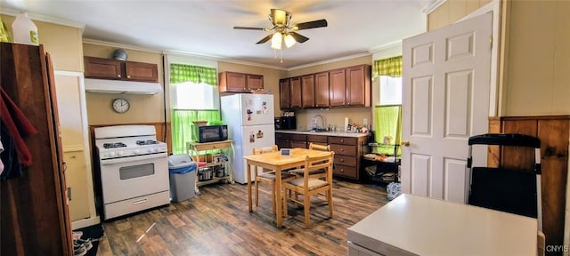 kitchen with white appliances, a ceiling fan, under cabinet range hood, and plenty of natural light