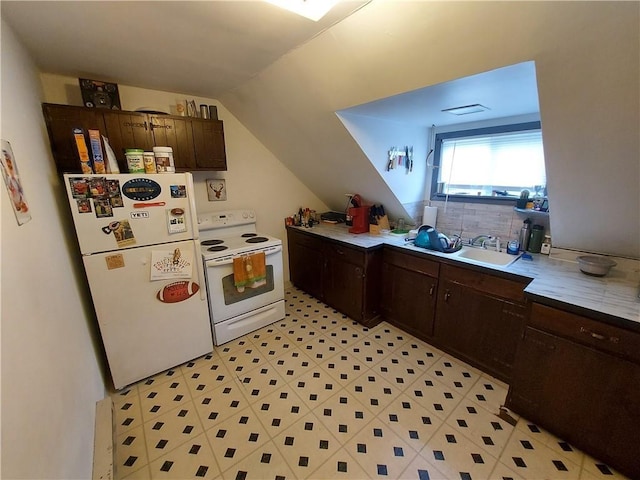 kitchen featuring dark brown cabinets, a sink, lofted ceiling, light floors, and white appliances