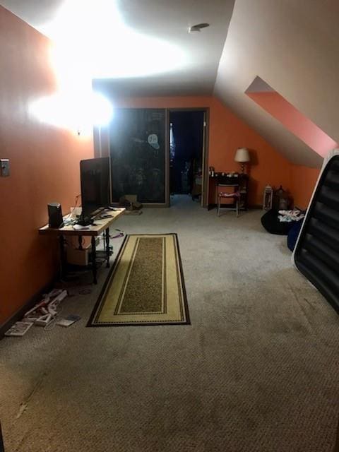 additional living space with carpet flooring and vaulted ceiling