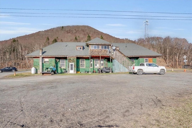 view of front of property featuring a mountain view and stairway