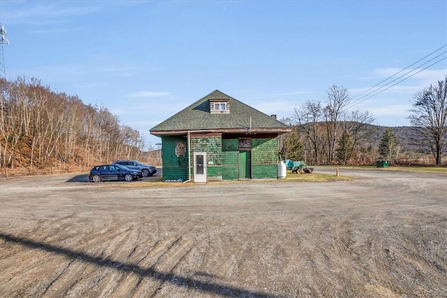view of outdoor structure featuring uncovered parking