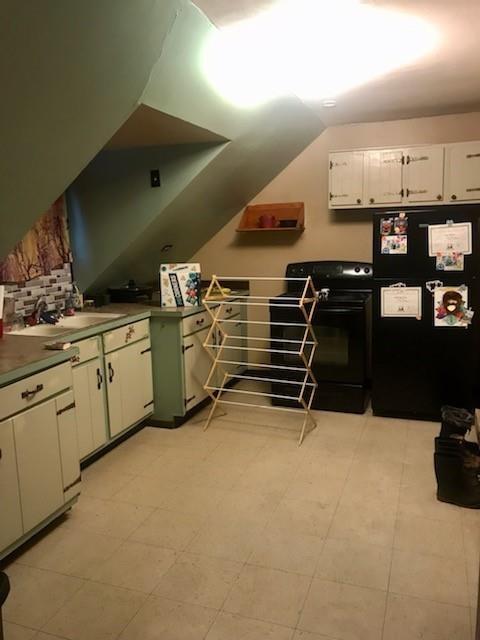 bonus room featuring vaulted ceiling and a sink