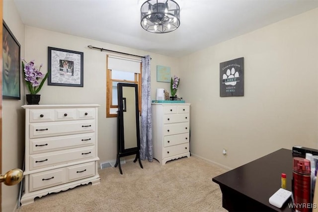 bedroom with baseboards, a notable chandelier, and light carpet