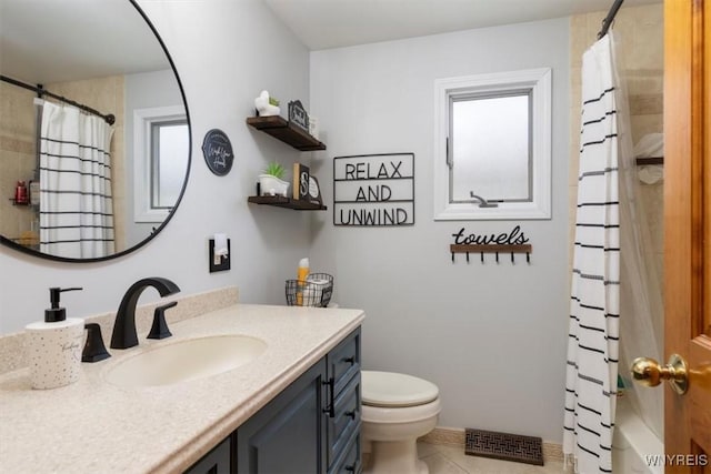 bathroom featuring tile patterned floors, vanity, toilet, and visible vents