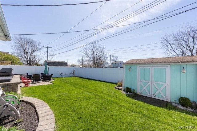view of yard with a fenced backyard, a storage unit, an outdoor structure, and a patio area