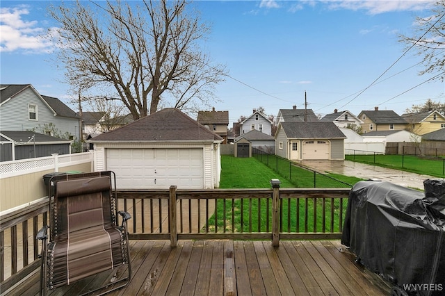wooden terrace with an outdoor structure, a garage, a fenced backyard, a lawn, and a residential view