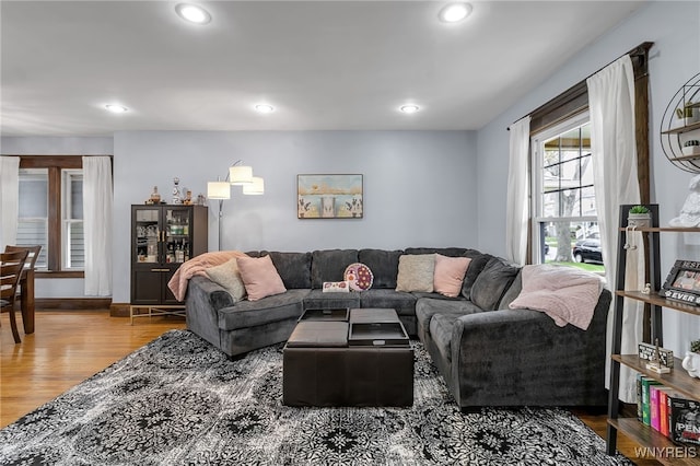 living area with recessed lighting and wood finished floors