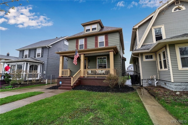 american foursquare style home with covered porch and a front lawn
