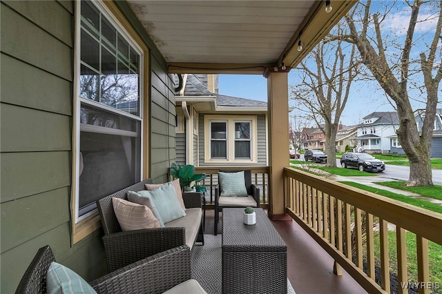 balcony featuring a residential view, covered porch, and an outdoor living space