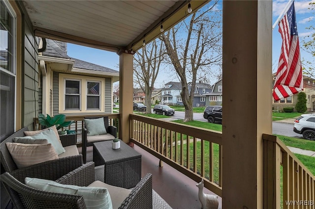 balcony featuring covered porch and a residential view
