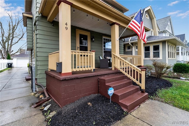 entrance to property featuring a garage and covered porch