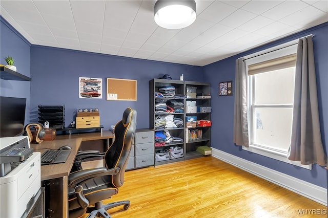 office space with baseboards and wood finished floors
