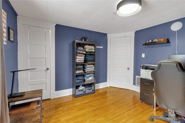 office featuring baseboards and light wood finished floors