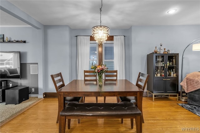 dining area with baseboards, recessed lighting, light wood-style flooring, and a chandelier