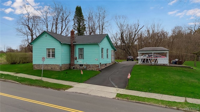 view of front of home with a chimney and a front yard