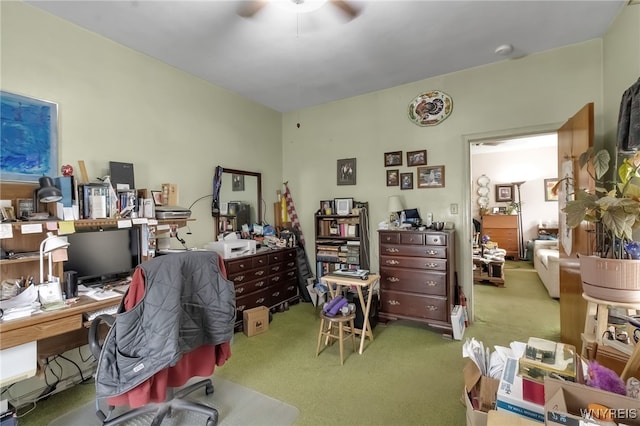 carpeted office with a ceiling fan