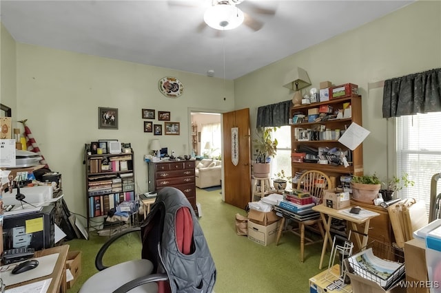 office area with a ceiling fan and carpet flooring