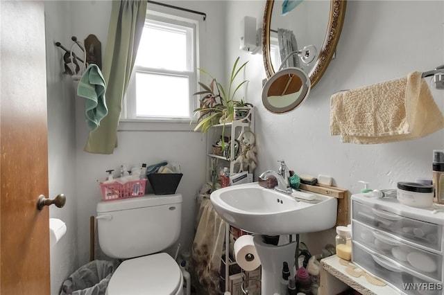 half bathroom featuring a sink and toilet