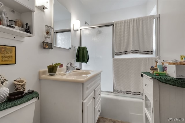 full bathroom with vanity, shower / bath combination with glass door, and toilet