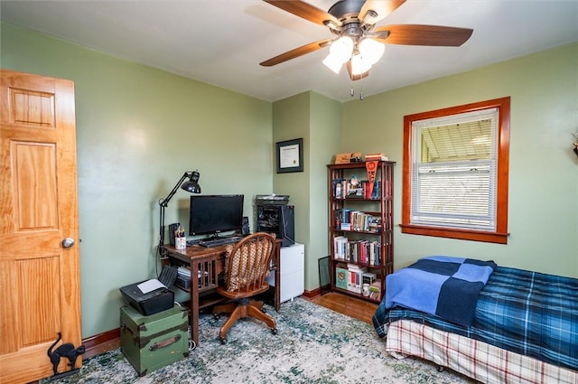 bedroom with baseboards, a ceiling fan, and wood finished floors
