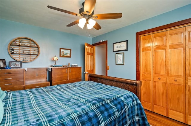 bedroom with a closet, a ceiling fan, and wood finished floors