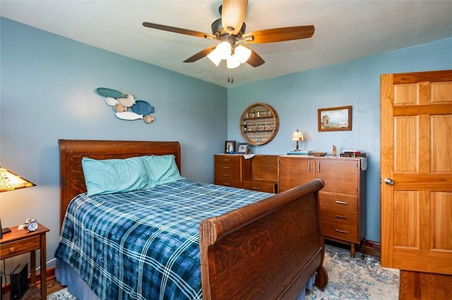 bedroom with baseboards, a ceiling fan, and wood finished floors