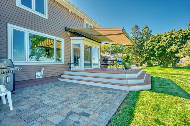 back of property featuring a yard, a patio area, and a deck